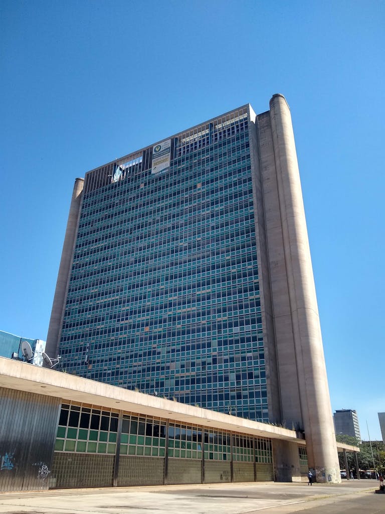 A striking view of a modern government building in Brasília, showcasing its architectural design against a clear blue sky.